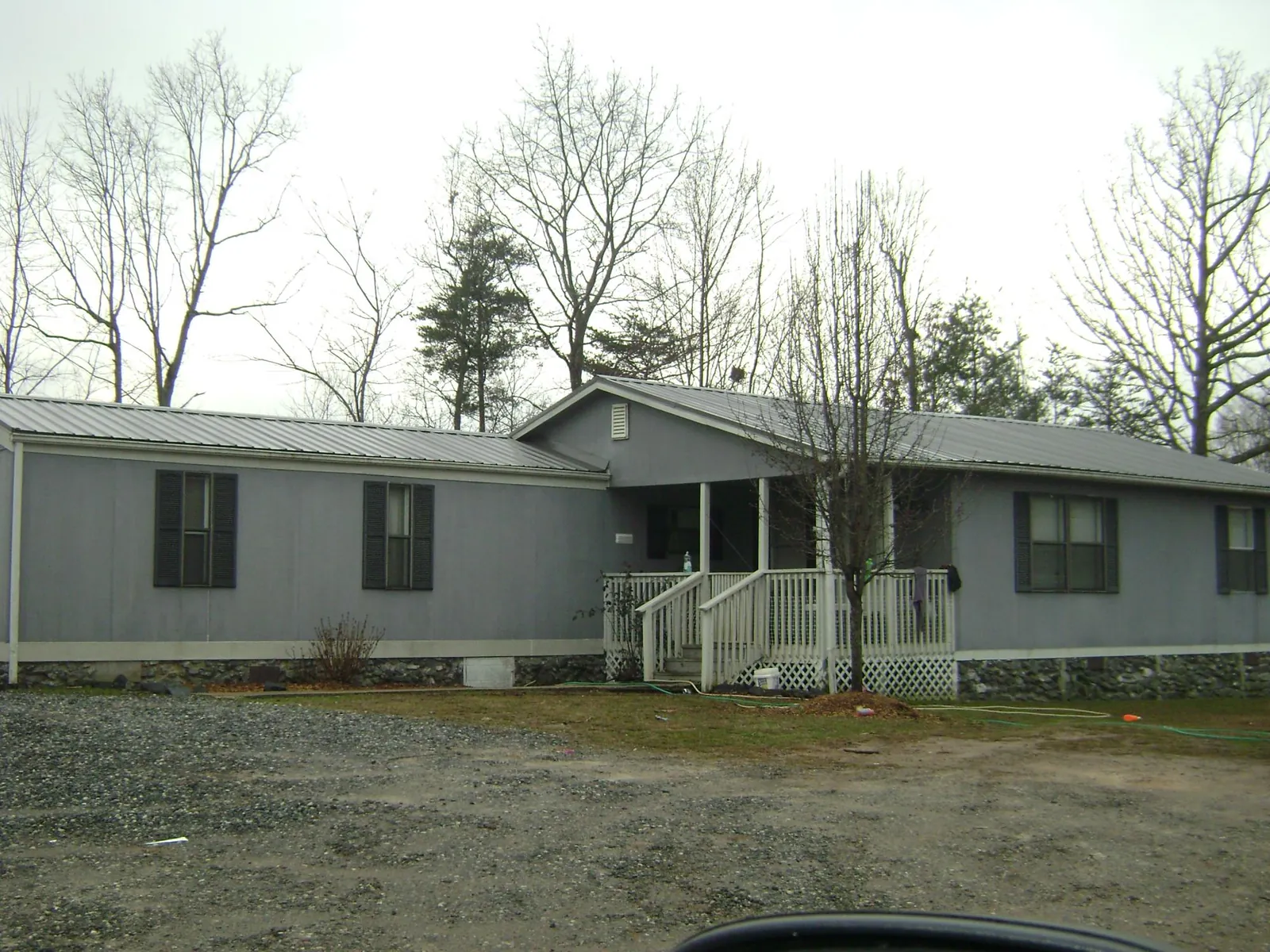 Metal roof over a manufactured home with a covered front porch in Corsicana