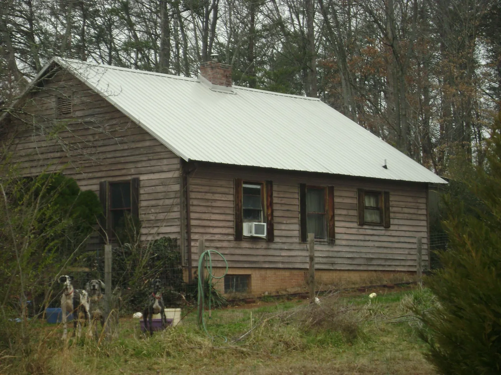 White metal roof on an old wood sided farmhouse, from a Metal Roof Installation job in Corsicana